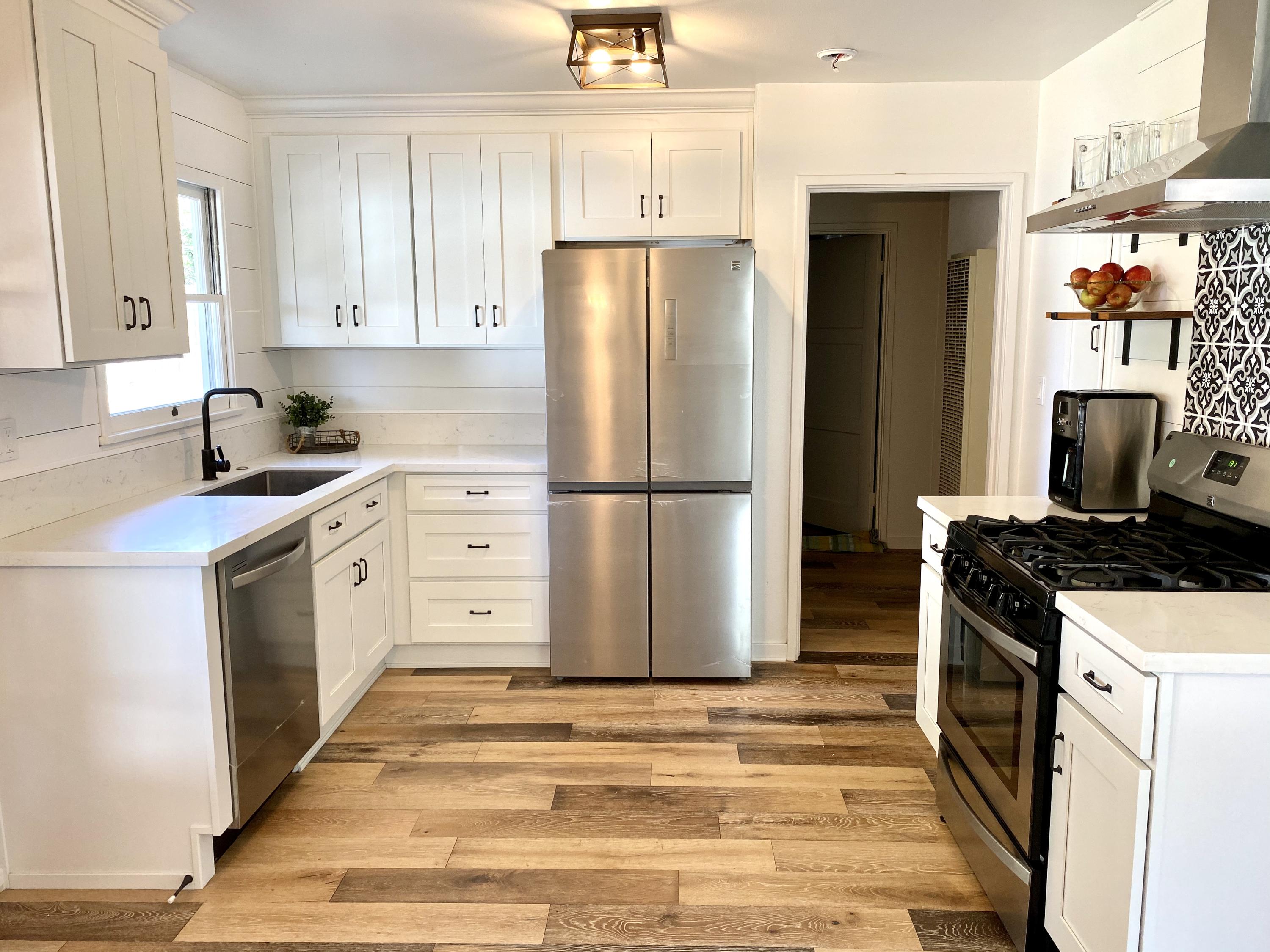 3048 Paseo Tranquillo Santa Barbara, CA 93105 - Photo 7 of 19 a kitchen with white cabinets and white appliances