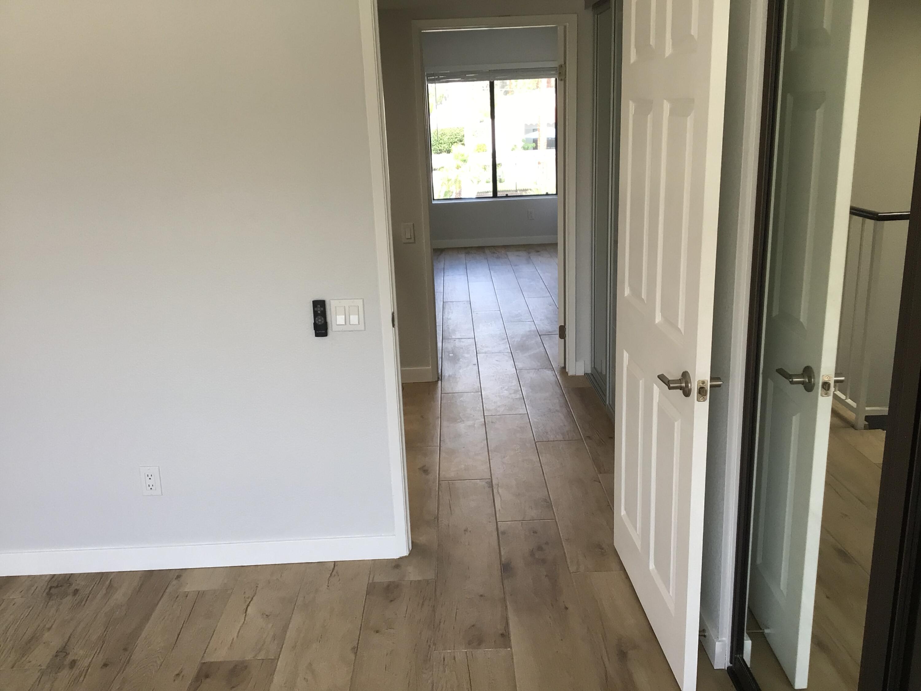 618 Violeta Drive Palm Springs, CA 92262 - Photo 31 of 35 a view of a hallway with wooden floor and a cabinet