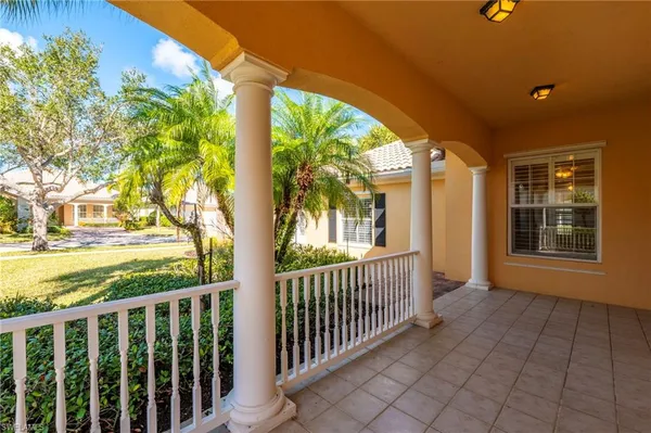 a view of a porch with wooden floor and fence