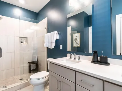 a bathroom with a toilet sink and shower
