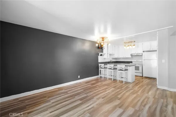 a view of a kitchen with wooden floor