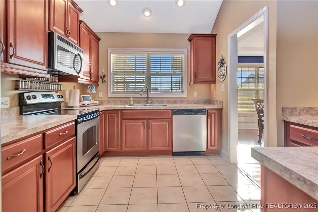 7453 7th Street Road Lumberton, NC 28358 - Photo 12 of 37 a kitchen with stainless steel appliances granite countertop a sink and a stove