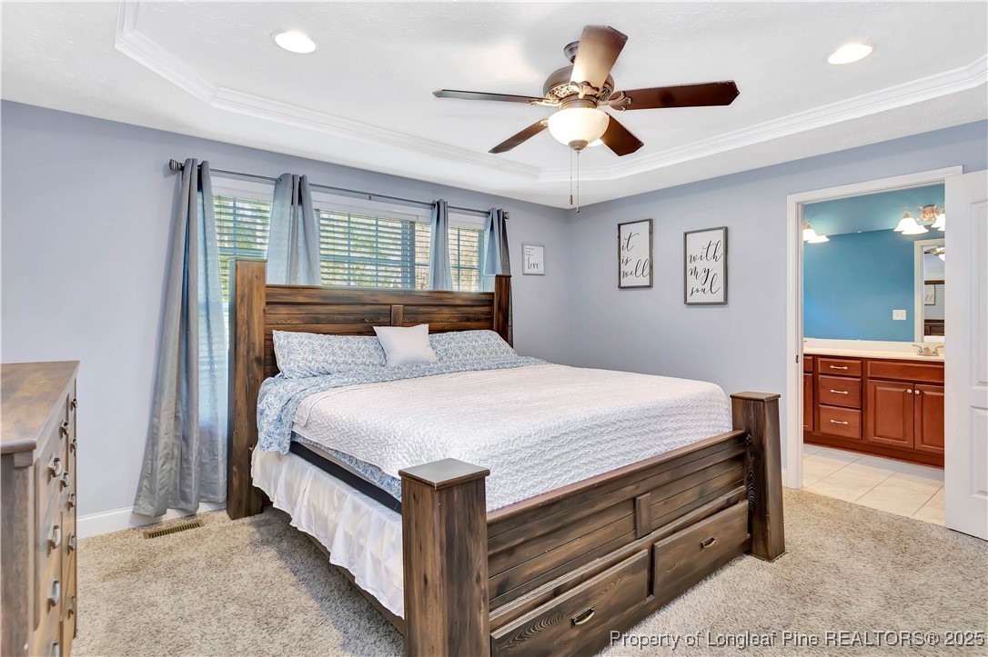 7453 7th Street Road Lumberton, NC 28358 - Photo 20 of 37 a bedroom with a bed and a ceiling fan