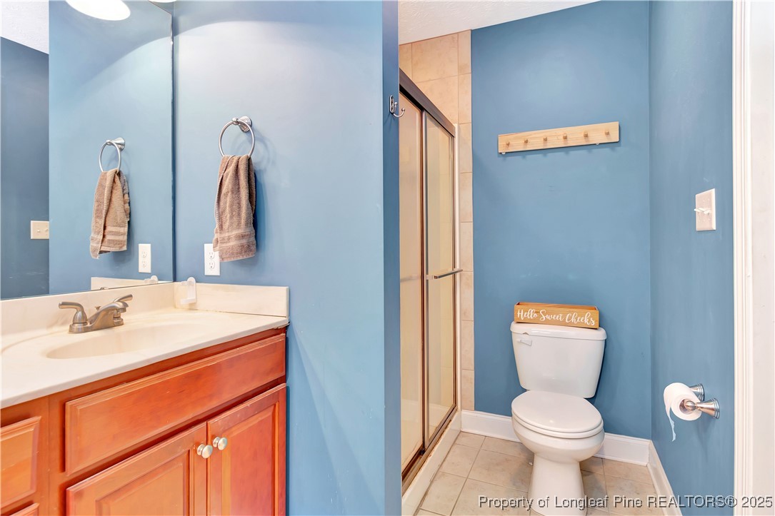 7453 7th Street Road Lumberton, NC 28358 - Photo 24 of 37 a bathroom with a toilet sink and mirror