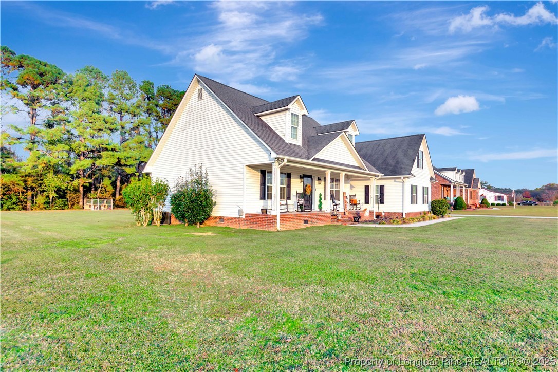 7453 7th Street Road Lumberton, NC 28358 - Photo 3 of 37 a front view of a house with garden