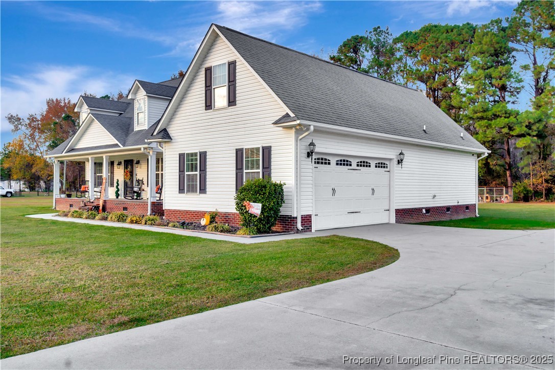 7453 7th Street Road Lumberton, NC 28358 - Photo 4 of 37 a front view of a house with a yard and garage