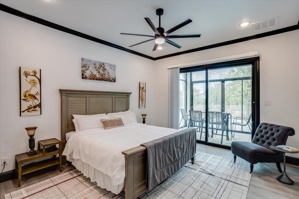 124 Cote D Azur Chico, TX 76431 - Photo 11 of 40 a bedroom with a large bed and a large window