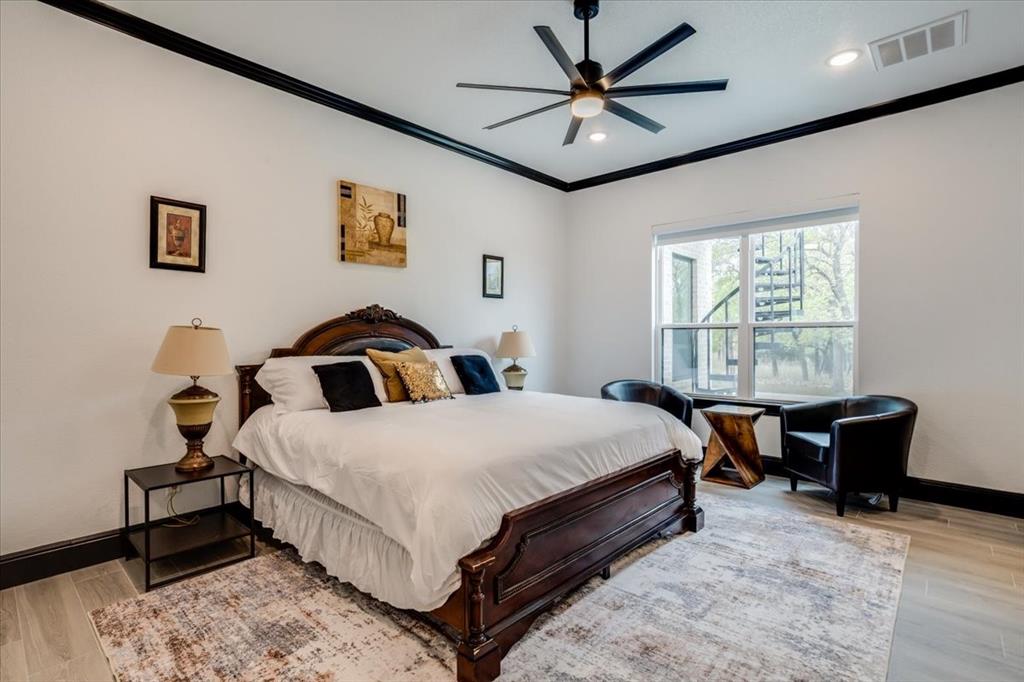 124 Cote D Azur Chico, TX 76431 - Photo 17 of 40 a bedroom with a bed and a large window