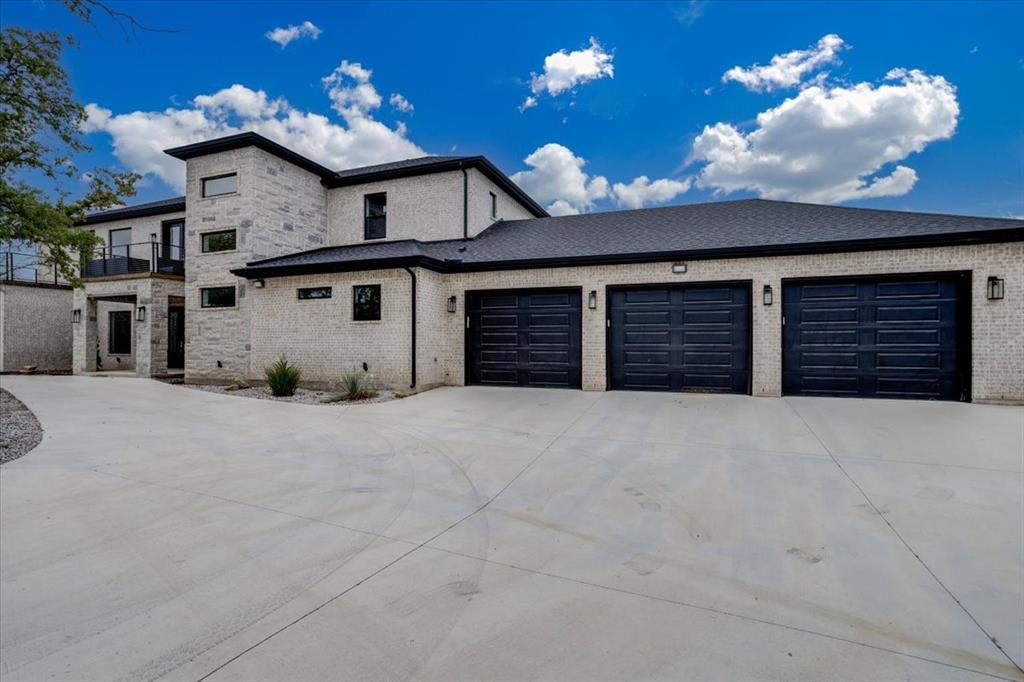124 Cote D Azur Chico, TX 76431 - Photo 2 of 40 a view of a house with a yard and garage