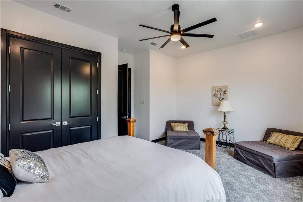 124 Cote D Azur Chico, TX 76431 - Photo 28 of 40 a bedroom with a bed and a chandelier