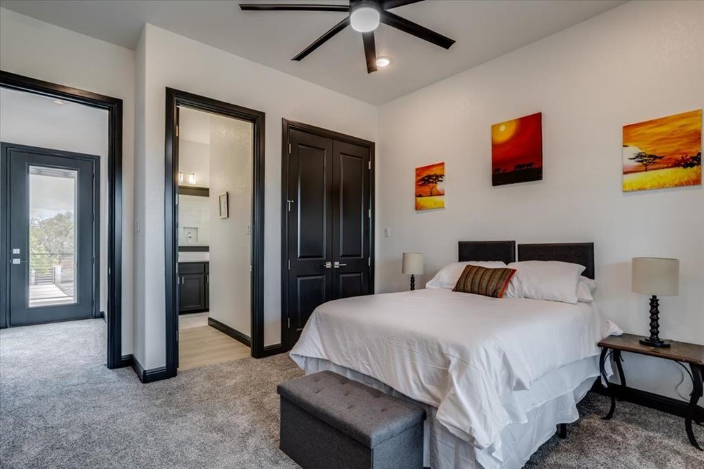 124 Cote D Azur Chico, TX 76431 - Photo 31 of 40 a bedroom with a bed and a chandelier