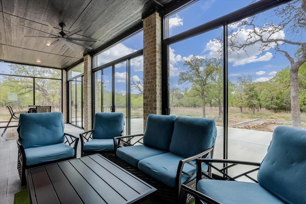 124 Cote D Azur Chico, TX 76431 - Photo 32 of 40 a living room with furniture and a floor to ceiling window
