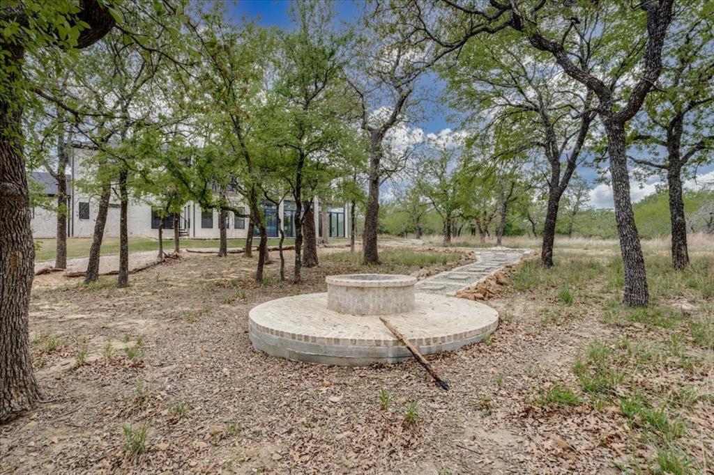 124 Cote D Azur Chico, TX 76431 - Photo 35 of 40 a backyard of a house with fountain table and chairs