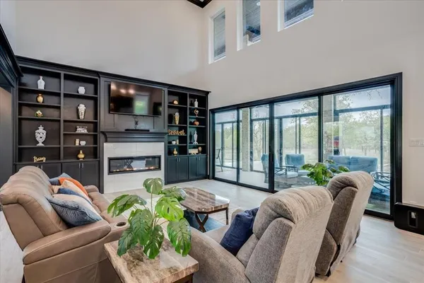 a living room with furniture and a floor to ceiling window