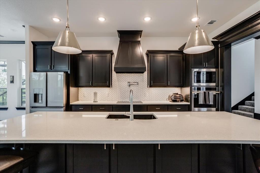 124 Cote D Azur Chico, TX 76431 - Photo 8 of 40 a kitchen with kitchen island counter space a sink and refrigerator