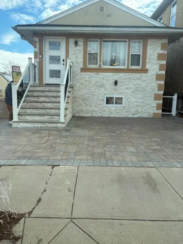 a front view of a house with stairs