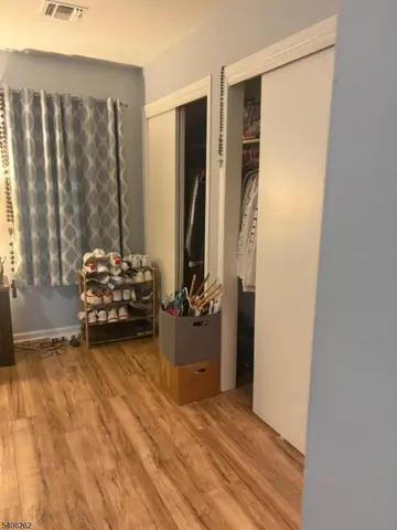 a view of room with closet and wooden floor