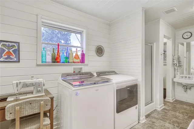 a utility room with a stove a washer and dryer