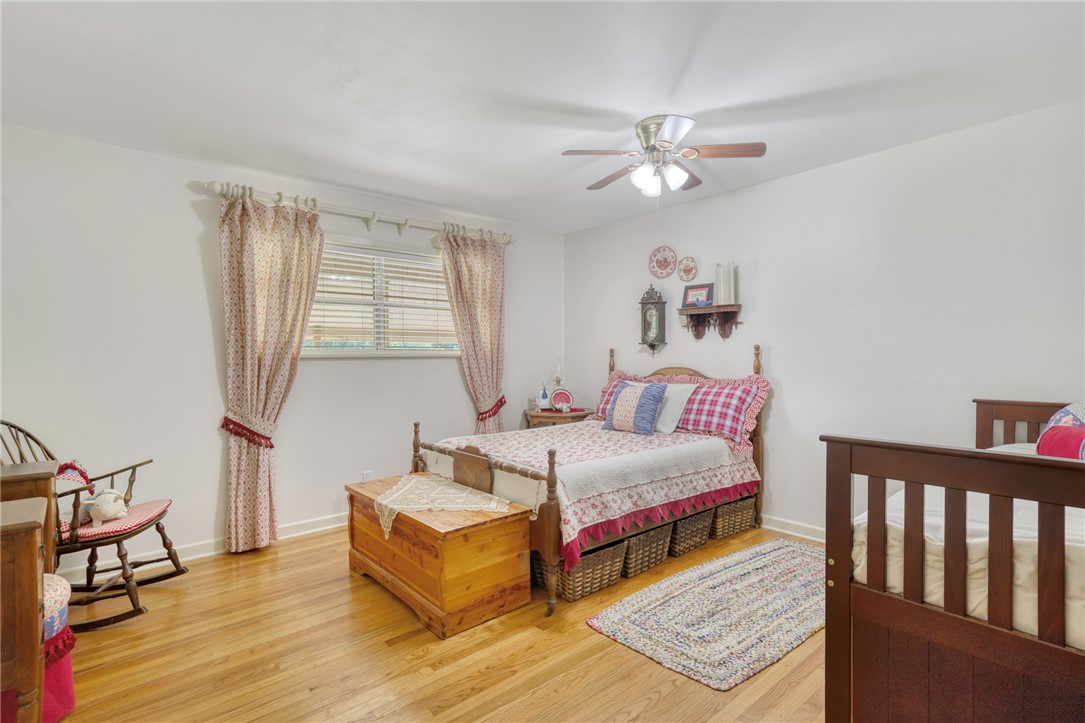 801 North Center Street Franklin, TX 77856 - Photo 26 of 32 Bedroom featuring wood finished floors and baseboards