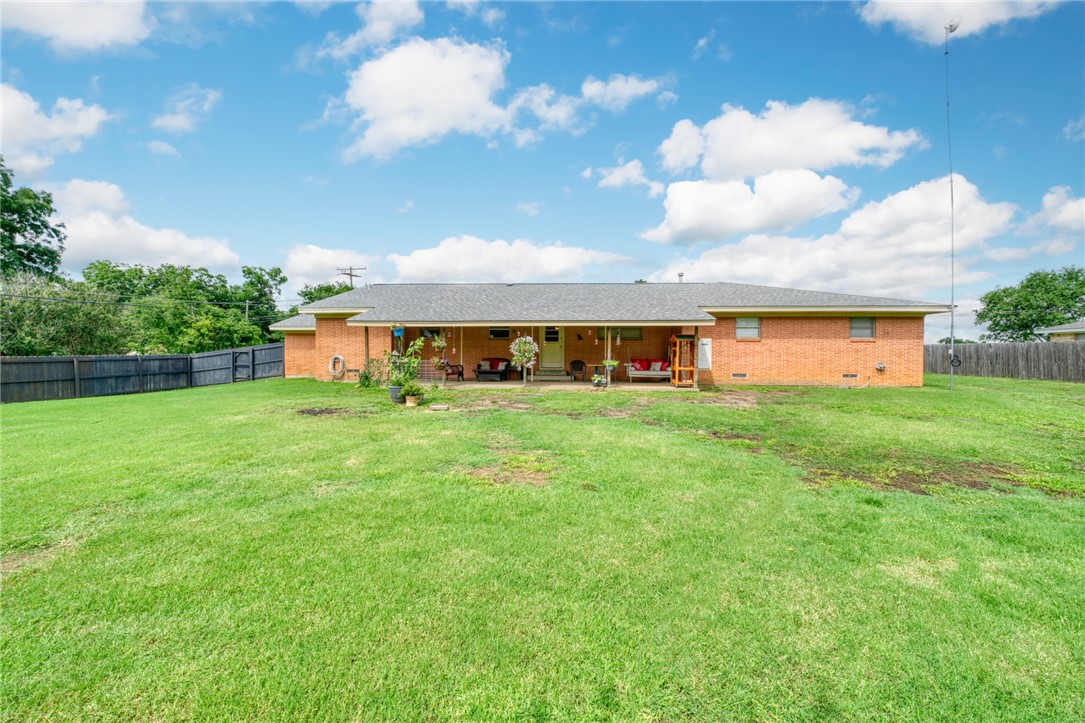 801 North Center Street Franklin, TX 77856 - Photo 29 of 32 Back of property with a patio, brick siding, and crawl space