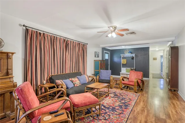 a living room with furniture a rug and a chandelier