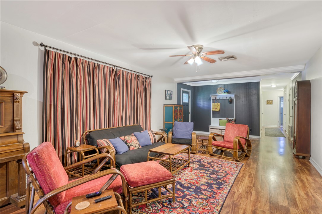 801 North Center Street Franklin, TX 77856 - Photo 8 of 32 Living area featuring wood finished floors, a ceiling fan, and baseboards