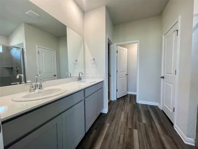 an empty room with a ceiling fan and window