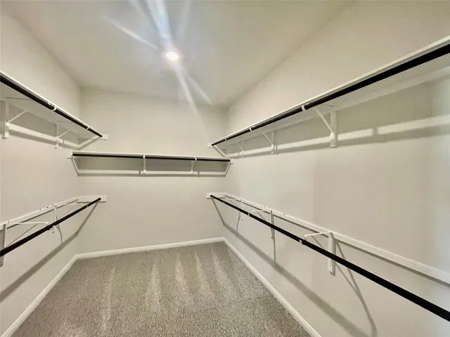 a en suite bathroom with a double vanity sink a mirror and a shower