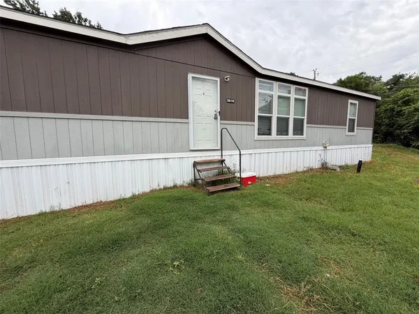 a view of backyard with a garden and deck