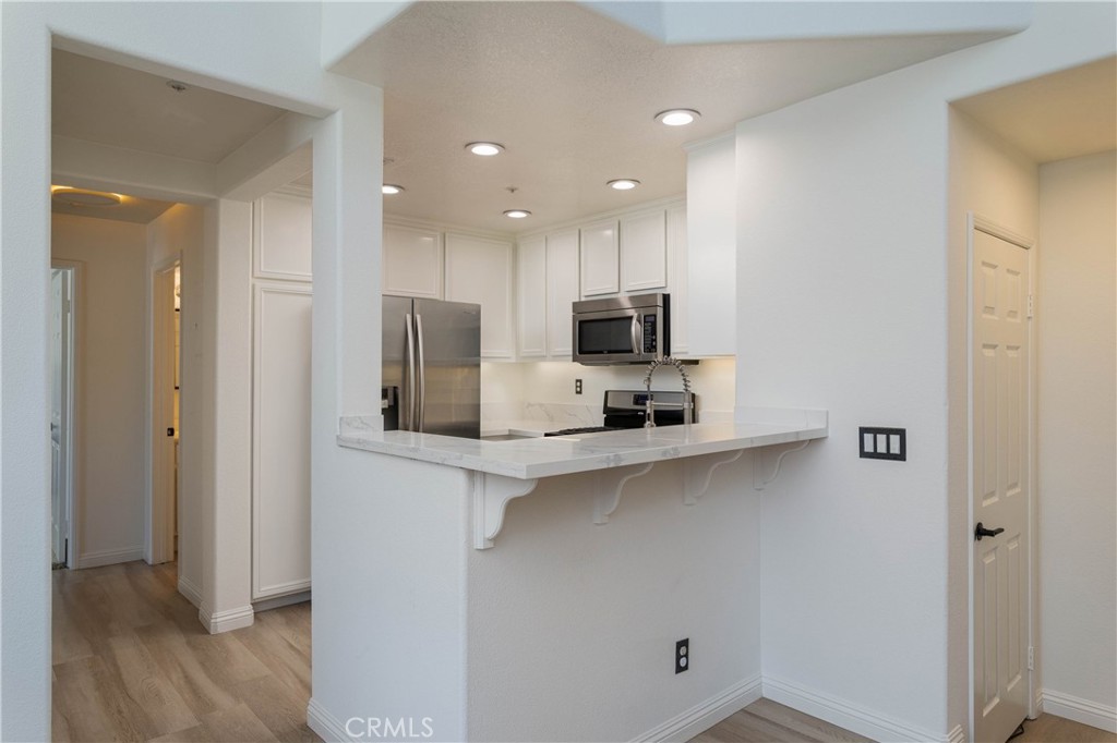 42 Chadron Circle Ladera Ranch, CA 92694 - Photo 9 of 27 a kitchen with stainless steel appliances a refrigerator sink and microwave