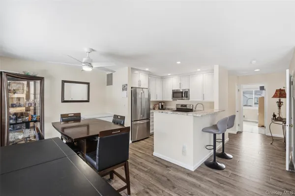 a living room with furniture and kitchen view