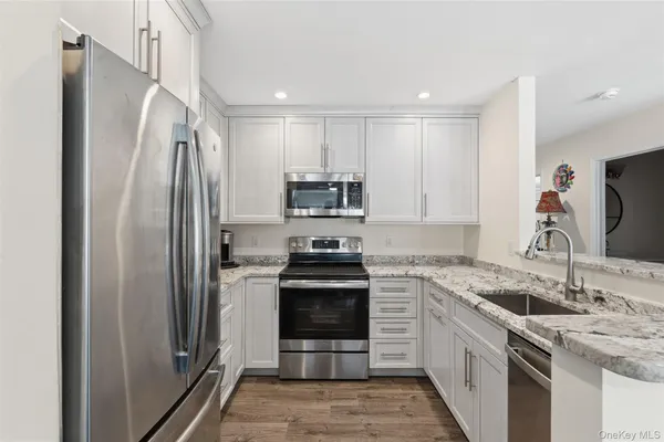 a kitchen with a sink stove and refrigerator