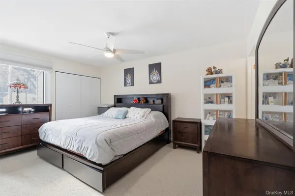 a bedroom with a large bed and a chandelier