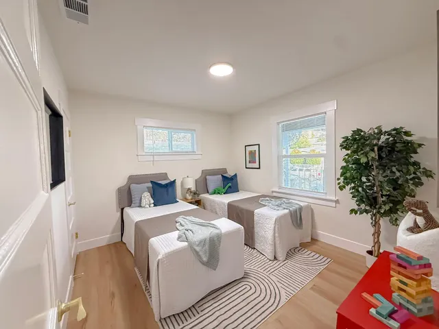a living room with furniture a chandelier and a window