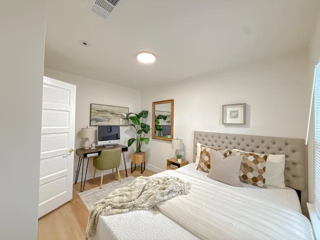 a bedroom with a bed and a chair