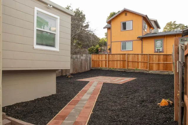 a view of a house with a wooden deck