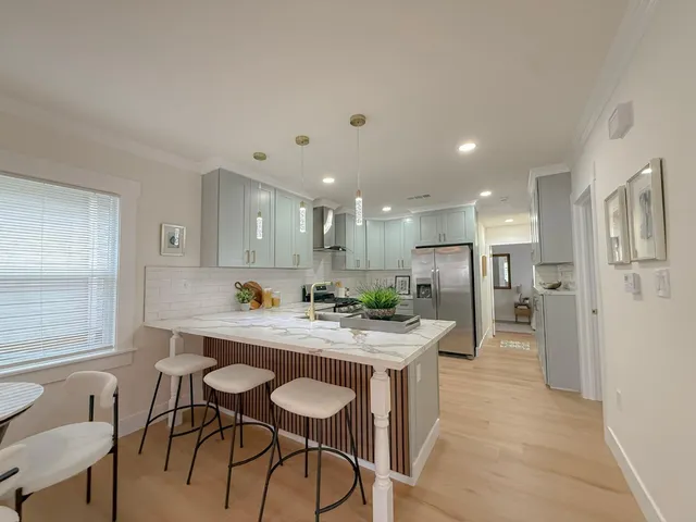 a kitchen with a table and chairs in it