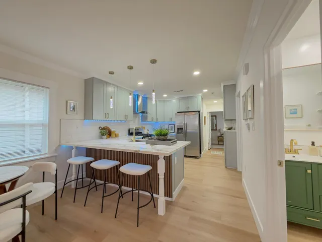 a kitchen with stainless steel appliances kitchen island granite countertop a sink and cabinets