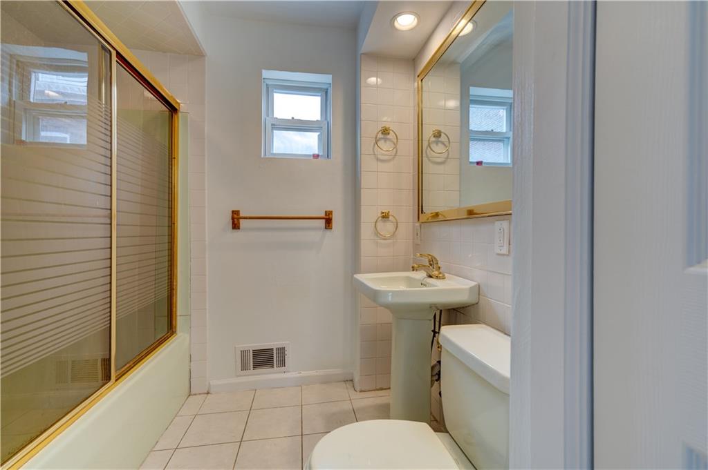 5264 Dresden Way Pittsburgh, PA 15201 - Photo 8 of 16 a bathroom with a sink toilet and shower