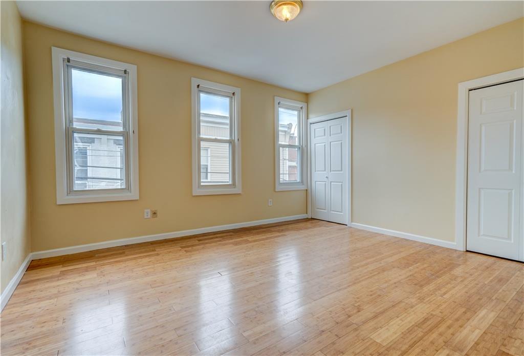 5264 Dresden Way Pittsburgh, PA 15201 - Photo 9 of 16 an empty room with wooden floor and windows