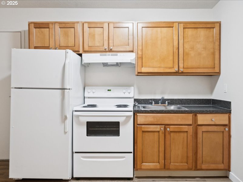 010 South Porter Street Portland, OR 97201 - Photo 3 of 11 a white stove top oven sitting inside of a kitchen