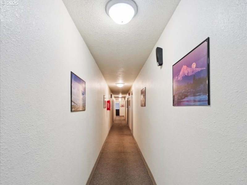 010 South Porter Street Portland, OR 97201 - Photo 10 of 11 a view of a hallway with wooden floor