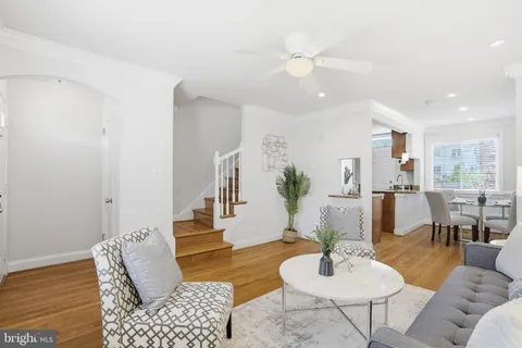 a living room with furniture and a dining table