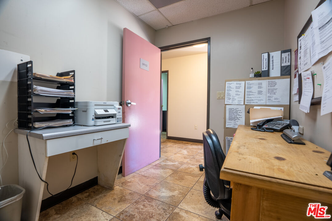 4946 Florence Avenue Bell, CA 90201 - Photo 31 of 72 a room that has a bed and a chair in it