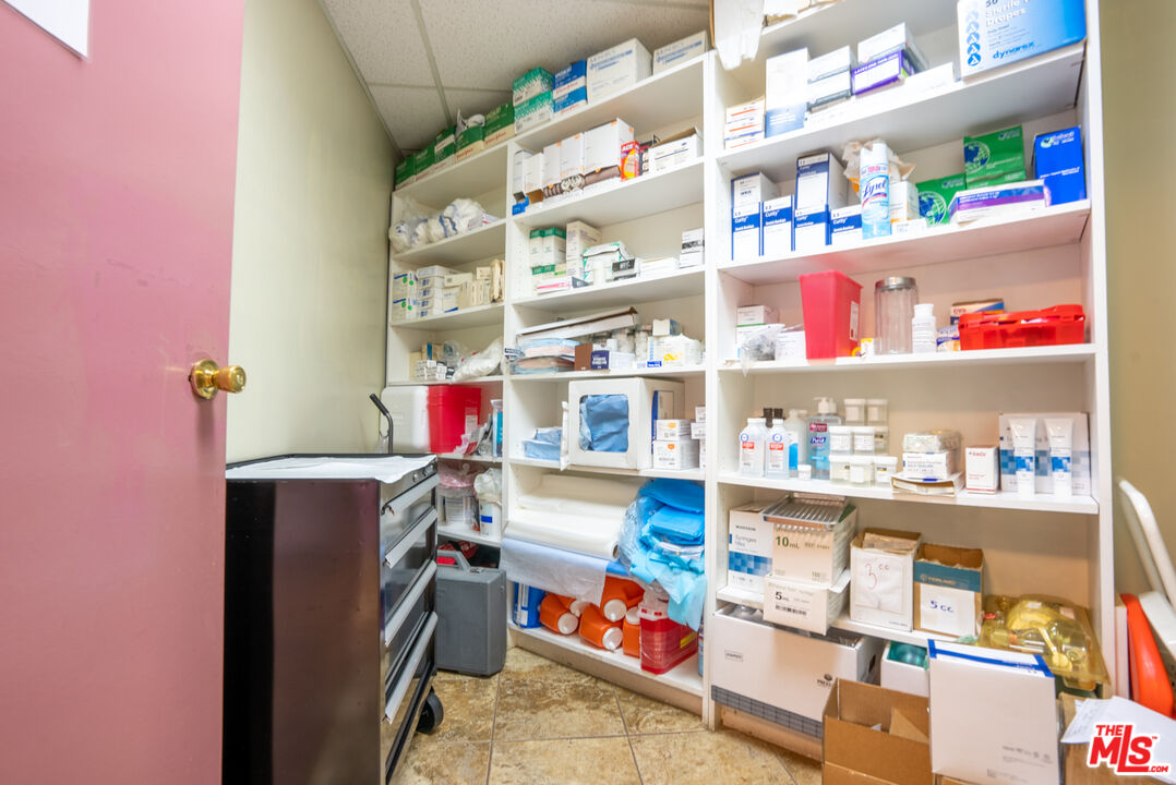 4946 Florence Avenue Bell, CA 90201 - Photo 41 of 72 a utility room with fridge toys and a book shelf