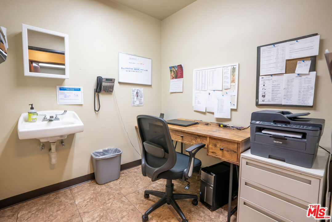 4946 Florence Avenue Bell, CA 90201 - Photo 55 of 72 a view of a workspace with furniture and a window