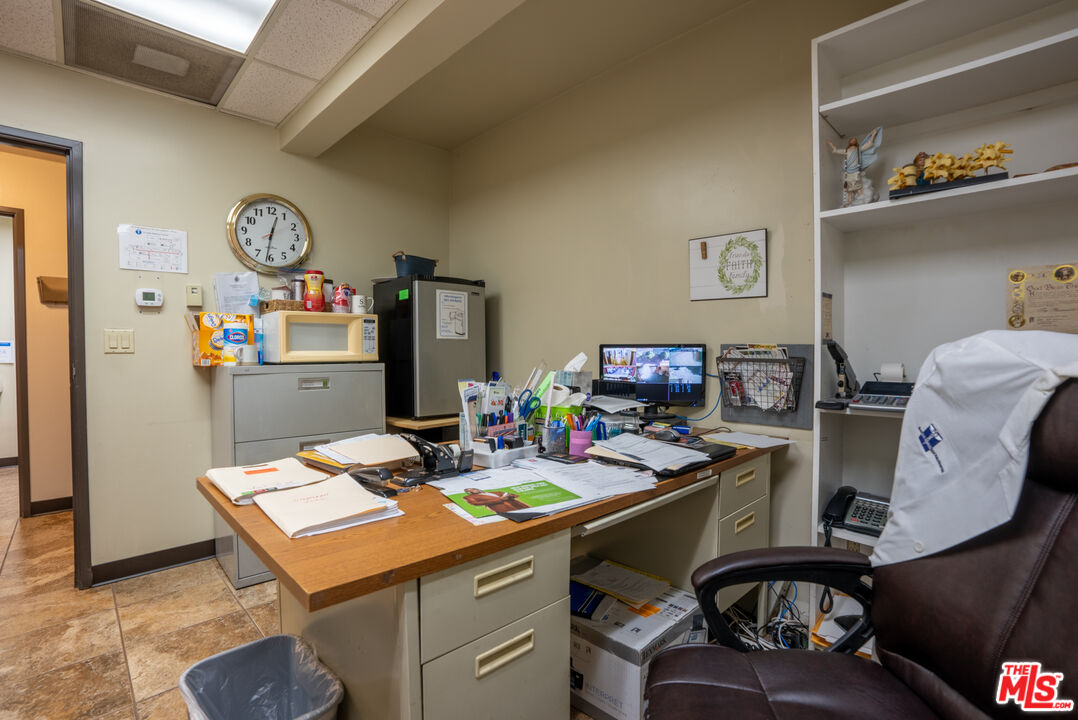 4946 Florence Avenue Bell, CA 90201 - Photo 59 of 72 a room with furniture a clock on wall and a table