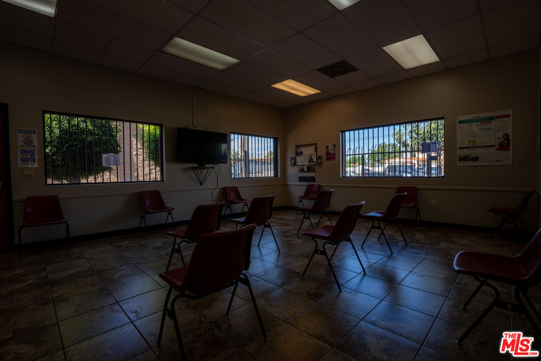 4946 Florence Avenue Bell, CA 90201 - Photo 63 of 72 a living room with furniture a window and a flat screen tv