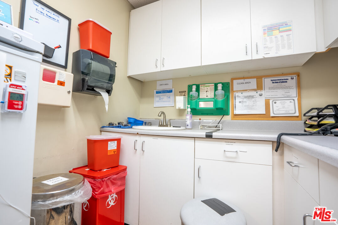 4946 Florence Avenue Bell, CA 90201 - Photo 10 of 72 a kitchen with stainless steel appliances a sink and a living room view