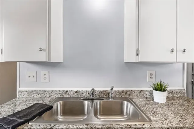 a kitchen with a sink and cabinets